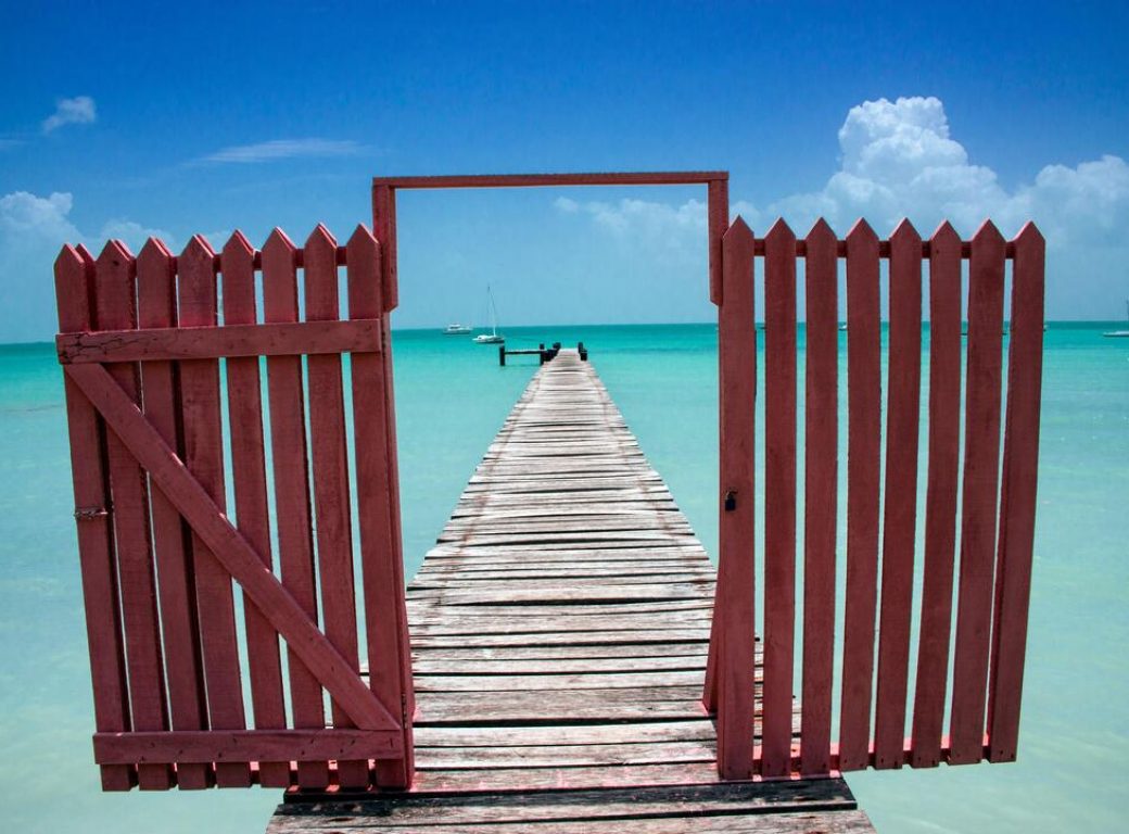 2D12T37 SARTENEJA, COROZAL DISTRICT / BELIZE - JUNE 2018: Fishing jetty and gateway in the coastal town of Sarteneja, Northern Belize.