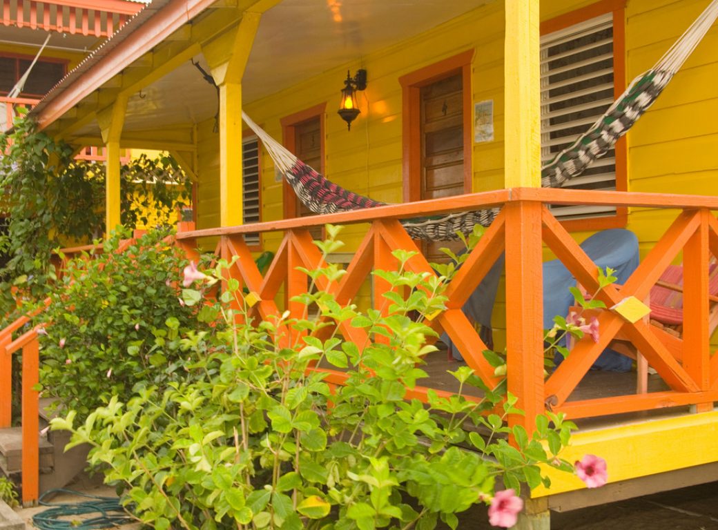 B08ENT Porch of colorful beach house, Placencia, Stann Creek District, Belize, Central America