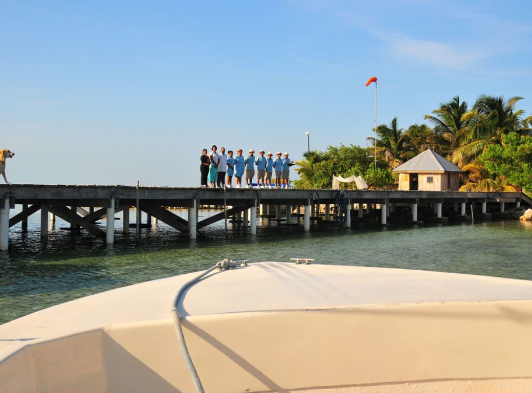 B66AFK The full staff of the luxurious Cayo Espanto in Belize welcomes all arriving guests to their private island resort villas.